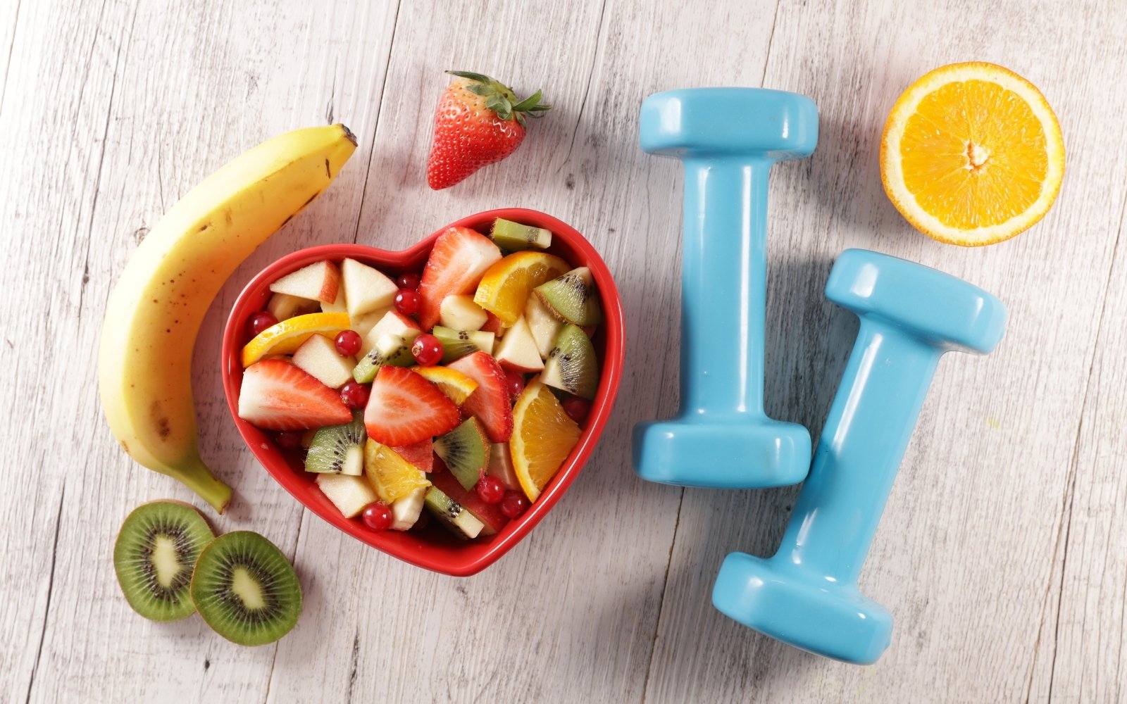 Fruits in a bowl and hand weights