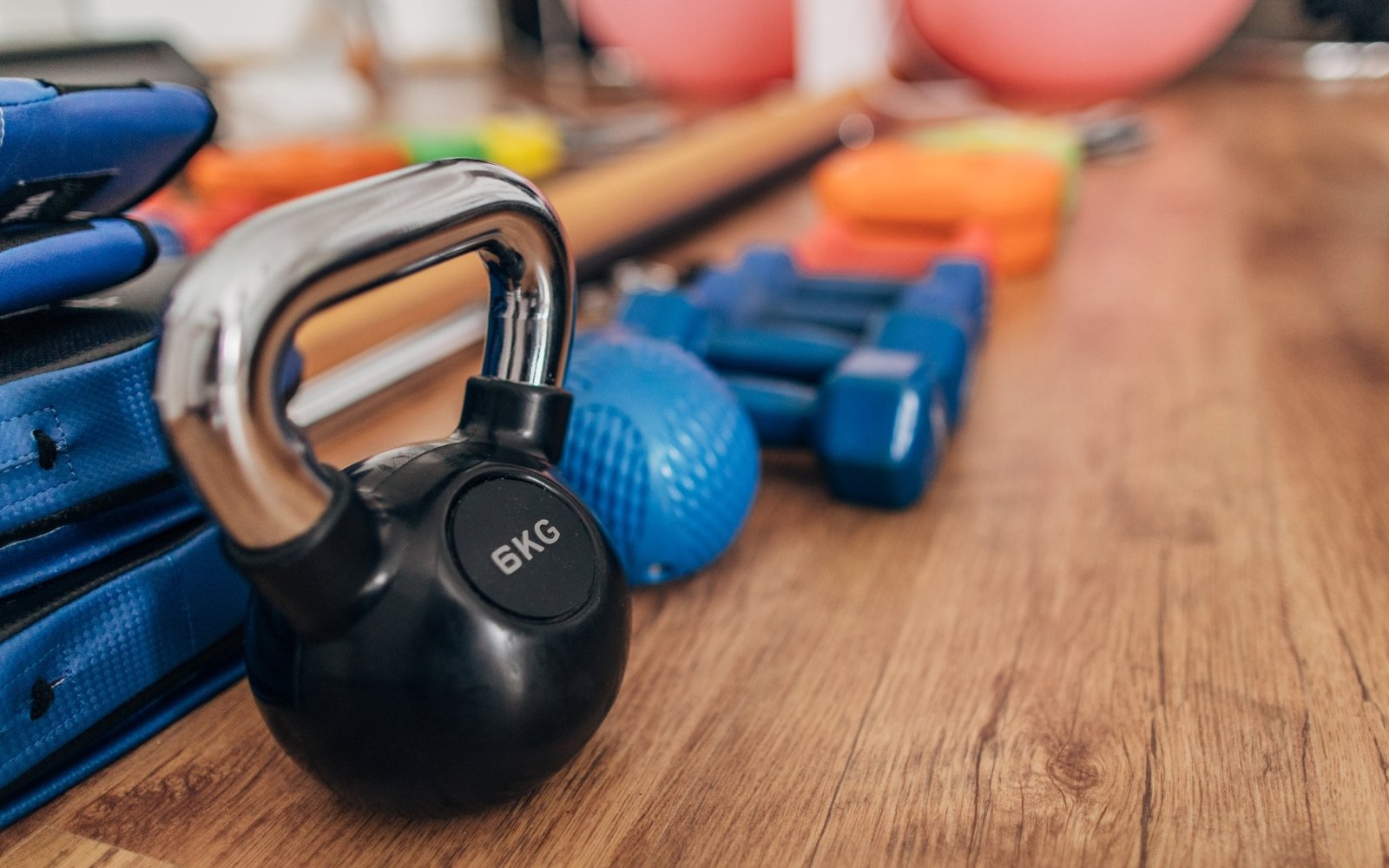 Kettlebell and weights on wooden gym floor