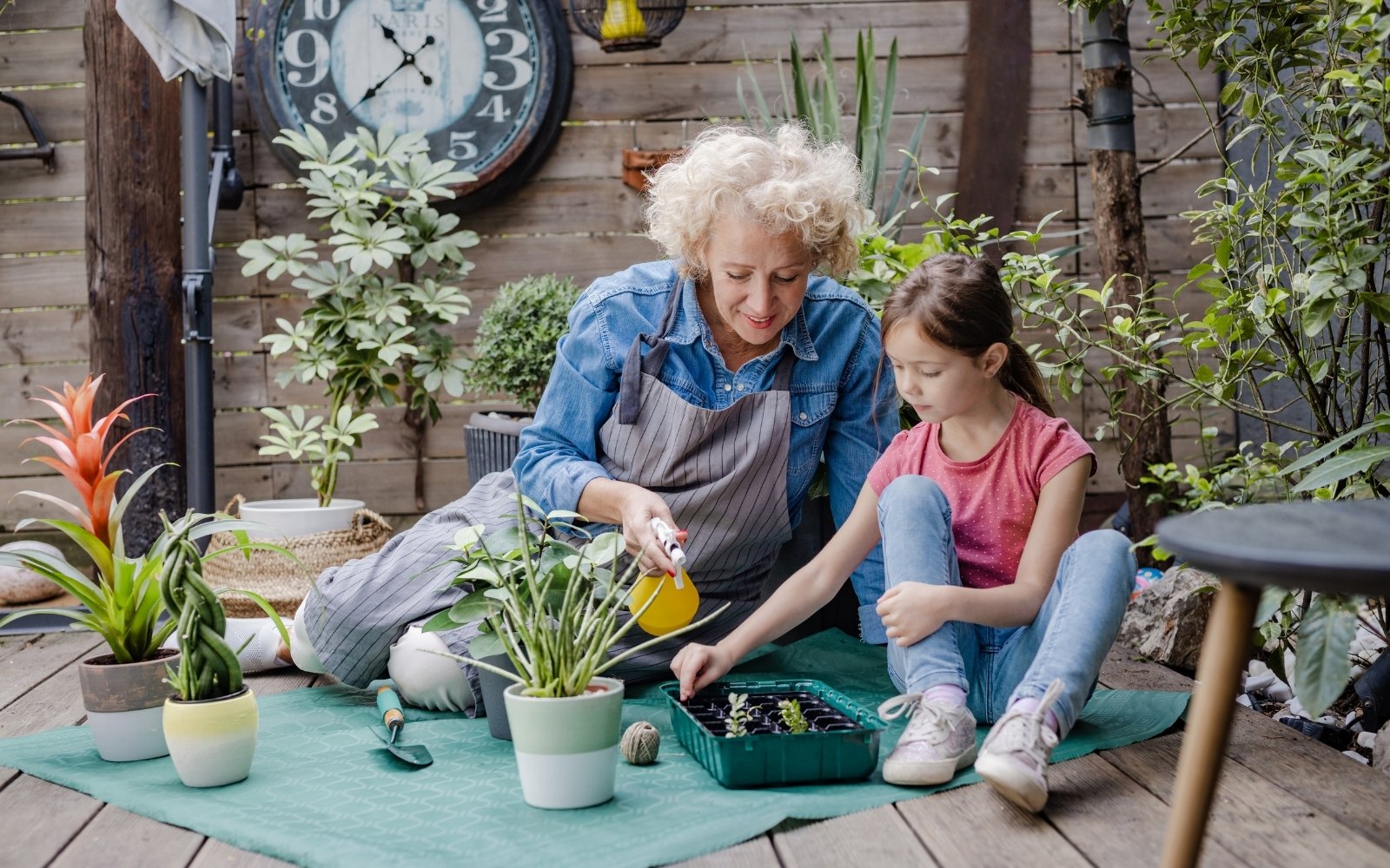 Older woman and young girl gardening together