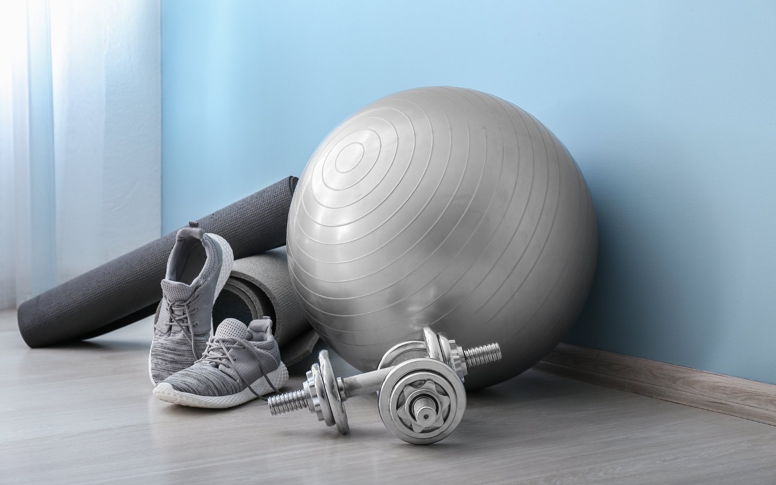 Silver gym equipment in front of blue wall